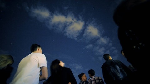 Menschen schauen in den Nachthimmel. Wer am Abend des 3. Januars 2026 in den Nachthimme schaut, hat Chancen, die Sternschnuppen der Quadrantiden über Deutschland zu sehen.