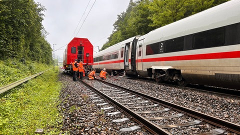 DB-Mitarbeiter untersuchen die Unfallstelle eines entgleisten Zuges nach einem Erdrutsch bei Schwäbisch Gmünd.