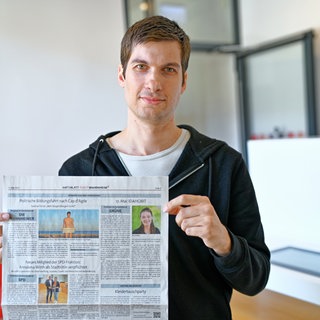 Julien Ferrat hält das aktuelle Amtsblatt mit seinem Artikel in den Händen.