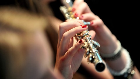 Eine junge Frau spielt Querflöte. Das Symbolbild dient zur Illustration zum Thema Machtmissbrauch an Musikhochschulen in Baden-Württemberg.