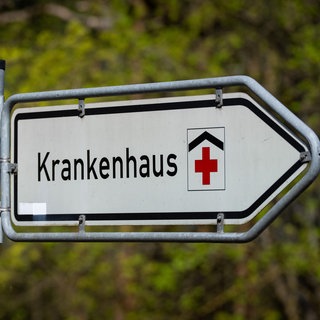 Ein Schild weist den Weg zu einer Klinik. Die Krankenhausreform soll überarbeitet werden. Auch BW hat Änderungswünsche.