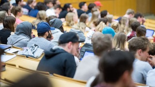 Studierende sitzen in einem Hörsaal in einer Vorlesung (Symbolbild).