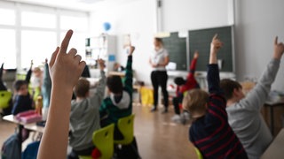 Schüler einer Grundschule arbeiten in einem Klassenzimmer an Mathematikaufgaben. Eine Arbeitsgruppe der Landesregierung hat herausgefunden, dass in BW zweitweise rund 2.500 Lehrerstellen unbesetzt geblieben sind.