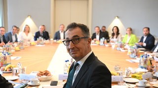 Cem Özdemir (Bündnis 90Die Grünen), Ministerpräsident von Baden-Württemberg, sitzt zum Auftakt einer Kabinettssitzung mit anderen Mitgliedern der baden-württembergischen Landesregierung im Kabinettssaal der Villa Reitzenstein, dem Sitz des Staatsministeriums, am Kabinettstisch. 