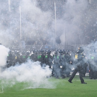 Polizisten stehen vor dem Fanblock des SV Waldhof Mannheim. Beim Pokalspiel Waldhof Mannheim gegen den 1. FC Kaiserslautern gab es dutzende Leichtverletzte.
