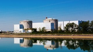 Die beiden Reaktorgebäude des Atomkraftwerks Fessenheim und eine anliegende Halle sind aus der Entfernung im Rheintal zu sehen (Archivbild).