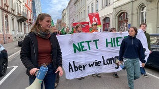 Klimaaktivistin Greta Waltenberg mit einem Megafon bei einer Demonstration durch Freiburg