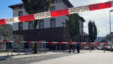 Ein rot-weißes Absperrband der Polizei ist um einen Platz in Oberndorf am Neckar gespannt.