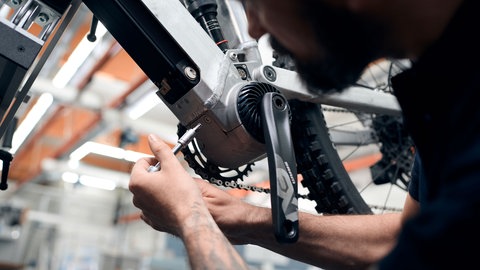 Ein Mechaniker baut den neuen E-Bike-Antrieb von ZF ein.