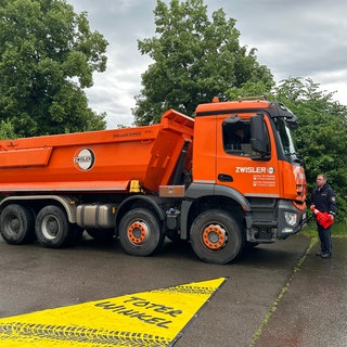 Sicherheitsrisiko toter Winkel: Auf dem Aktionstag in Tettnang veranschaulicht ein Dreieck vor einem Lkw, Verkehrsteilnehmer wie Kinder übersehen werden können
