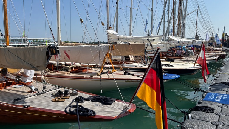 Ein Boot im Konstanzer Hafen hat eine Deutschlandflagge an Deck.