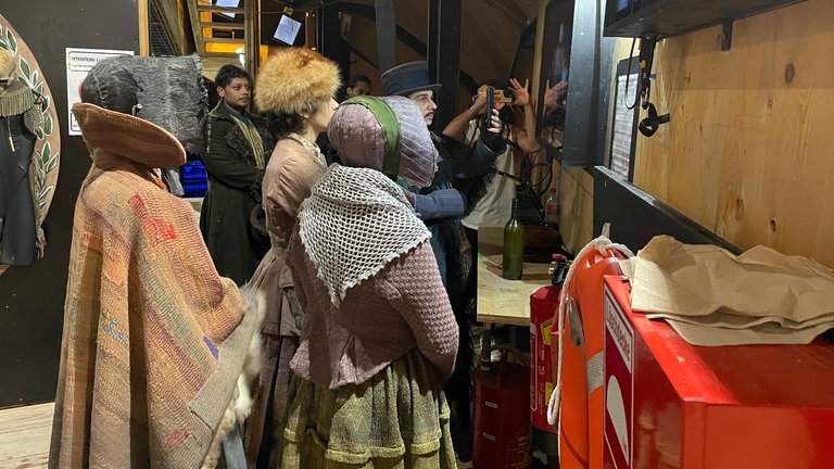 Solisten, Chor, Stuntleute, Maskenbildnerinnen und Regieassistentinnen wirbeln unter der Seebühne bei "Der Freischütz" der Bregenzer Festspiele.