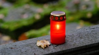 Eine Kerze auf einem Friedhof. An Allerheiligen besuchen viele Menschen in Oberschwaben und am Bodensee die Friedhöfe. 