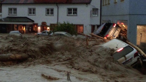 Die Flutwelle reißt Autos mit durch den Ortskern der Gemeinde Braunsbach