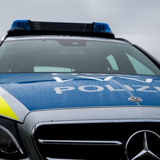 Ein Polizeiauto mit regennasser Front