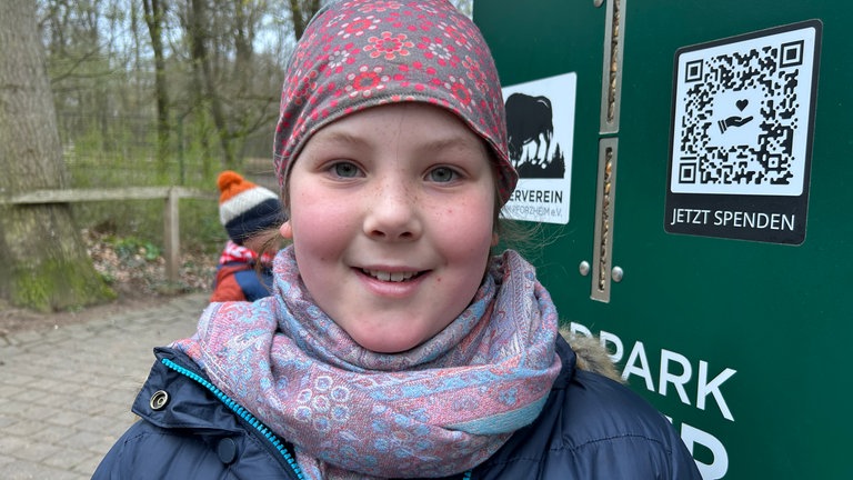 Ein Mädchen steht vor Ostern im Wildpark Pforzheim.