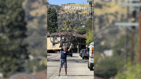 Jakob Alberti hält sein Fahrrad hoch