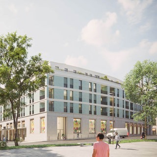 Ein neues Gebäude der Schlossberghöfe in Pforzheim steht zwischen zwei großen, grünen Bäumen.