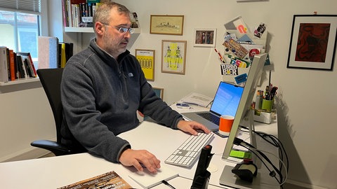 Matthias Grimm sitzt am Computer. Der Glasfaserausbau erleichtert seine Arbeit ungemein.
