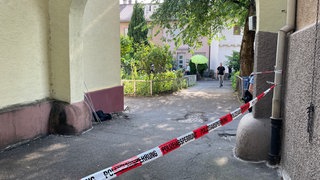 Ein Innenhof ist durch ein Band der Polizei abgesperrt.