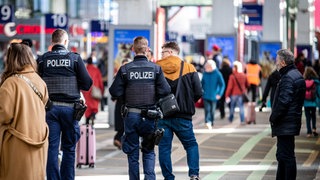 Zwei Polizisten gehen durch den Stuttgarter Hauptbahnhof.