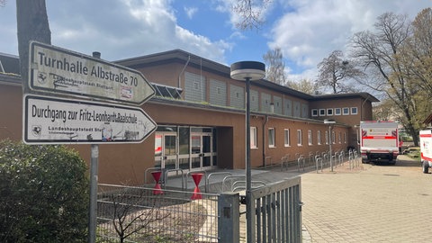 Vor einer Halle in Stuttgart-Degerloch stehen Rettungsfahrzeuge.