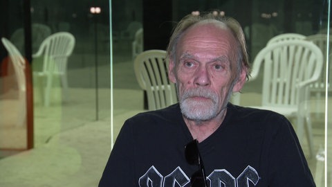 Roger sitzt in einem Stuhl. 