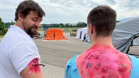 Mitglieder der Malteser Freiburg haben sich als Mimen Verletzungen schminken lassen. 
