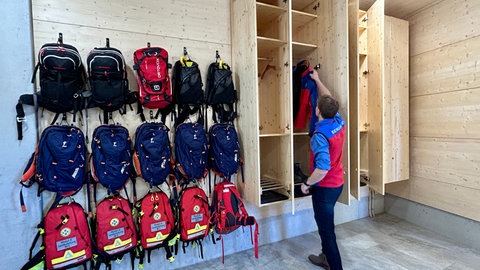 In der neuen Bergwacht arbeiten die Retter in ihrer rot-blauen Einsatzkleidung. Modernste Technik (Monitore, Einsatzfahrzeuge) unterstützen sie.