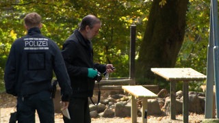 Zwei Polizeibeamte sichern Spuren am Fundort des toten Babys in Maulburg.