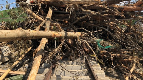 Bäume und Geröll liegen auf den Gleisen der Ahrtalbahn in Dernau