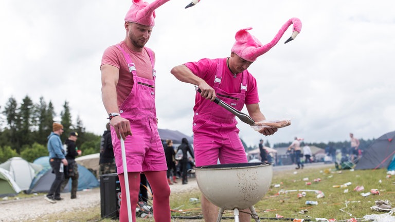 Zwei Männer grillen im Flamingo-Kostüm beim Rock am Ring Festival 2019 am Nürburgring.