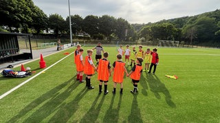 Zwölf Jungs der D-Jugend der Spielgemeinschaft Ahrtal stehen auf dem Kunstrasenplatz in Insul.