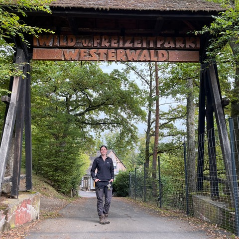 Geschäftsführerin Henrieke Böß steht unter dem Eingangsschild des Wildparks Westerwald.