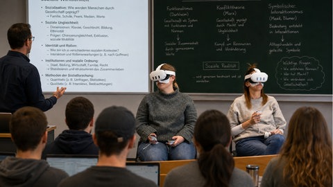Während einer Vorlesung tragen zwei Frauen eine VR-Brille. (Foto-Collage)