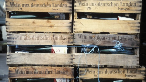 Holzkisten aus der Pfalz gefüllt mit Weinflaschen. Symbolbild. Mit Trumps Amtseinführung könnte sich der Weinhandel mit den USA für Pfälzer Winzer verteuern. Viele Unternehmen in der Pfalz sind anlässlich des Amtsantritts von Donald Trump besorgt.
