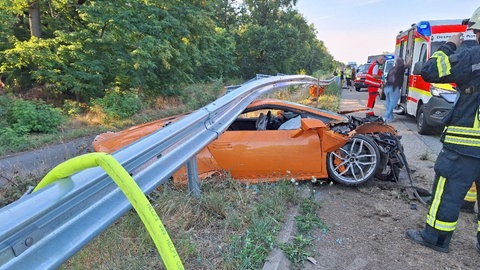 Der am Unfall auf der A65 bei Neustadt beteiligte Lamborghini steht zerstört unter einer Leitplanke. Der Fahrer blieb unverletzt. 