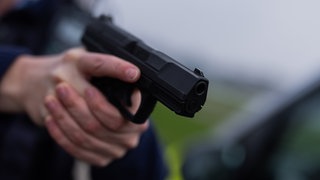 Eine Pistole in einer Hand. Ein Sicherheitsdienst in Bad Kreuznach möchte seinen Mitarbeitern Waffen zur Verfügung stellen. 