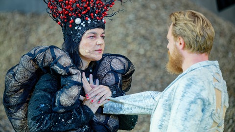 Jasmin Tabatabai als Drache und Eivin Nilsen Salthe als Siegfried stehen am Wormser Dom für das Stück „See aus Asche“ der Nibelungen-Festspiele auf der Bühne