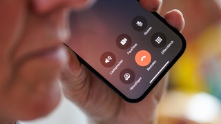 Ein älterer Mann führt ein Telefongespräch. In Mainz warnt die Polizei aktuell vor einer Welle von Callcenter-Betrug.