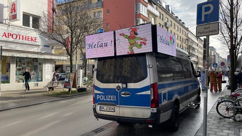 Ein Polizeiauto mit Helau-Aufschrift beim Rosenmontagszug in Mainz.