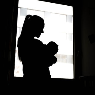 Eine Mutter hält ihr neugeborenes Baby im Arm. Schäden bei Kindern durch Alkohol in der Schwangerschaft werden oft erst Jahre später diagnostiziert.  