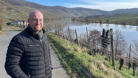 Ein Winzer steht im Weinberg, oberhalb von Piesport an der Mosel. 