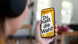 Europawahl 2024 Wahl-O-Mat ist online: Hand hält Smartphone mit Wahl-O-Mat-App