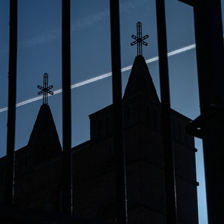 Symbolbild: Schatten der Vergangenheit. Siluette von zwei engstenden Kirchtürmen