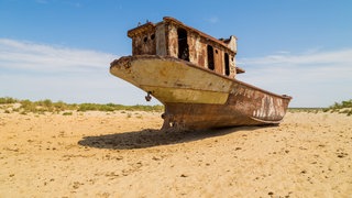 Trockengefallenes Boot am Aralsee: Noch in den 1960er-Jahren war der Aral in Zentralasien der viertgrößte See der Welt. Heute ist von ihm nur ein Zehntel seiner einstigen Fläche geblieben. Statt des Wassers macht sich Wüste breit. Kasachstan und Usbekistan haben zunehmend Probleme.