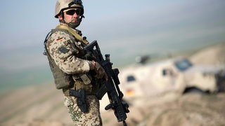 Ein Soldat der Bundeswehr sichert 2013 bei Masar-i-Scharif in Afghanistan mit seinem Gewehr ein Tal. Nach dem Abzug der Bundeswehr aus Afghanistan im August 2021 ringen einige Soldat*innen mit den psychischen Folgen des Einsatzes. Manche werden ernsthaft krank: Diagnose Posttraumatische Belastungsstörung (PTBS). 