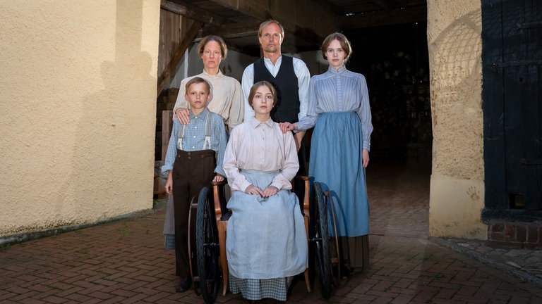 Familienporträt der Familie Steiff: Margarete (Martha Haberland, mi.), Bruder Fritz (Franz Röbig, li.), Mutter Maria Steiff (Tessa Mittelstaedt), Vater Friedrich Steiff (Wolfgang Vogler) und Schwester Pauline (Lilith Johna).