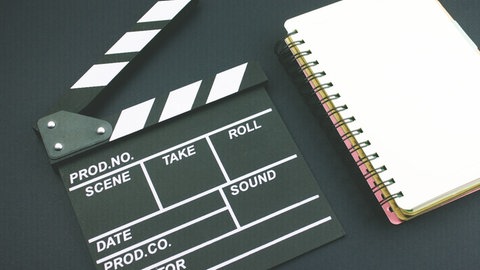 Filmklappe und Script-Block. © Colourbox