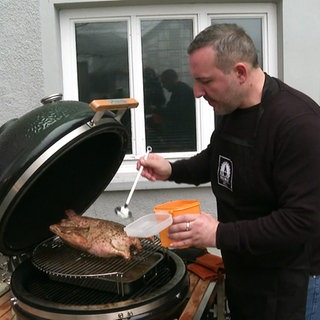 Zeki Cabirio bereitet eine Weihnachtsgans auf dem Grill zu.